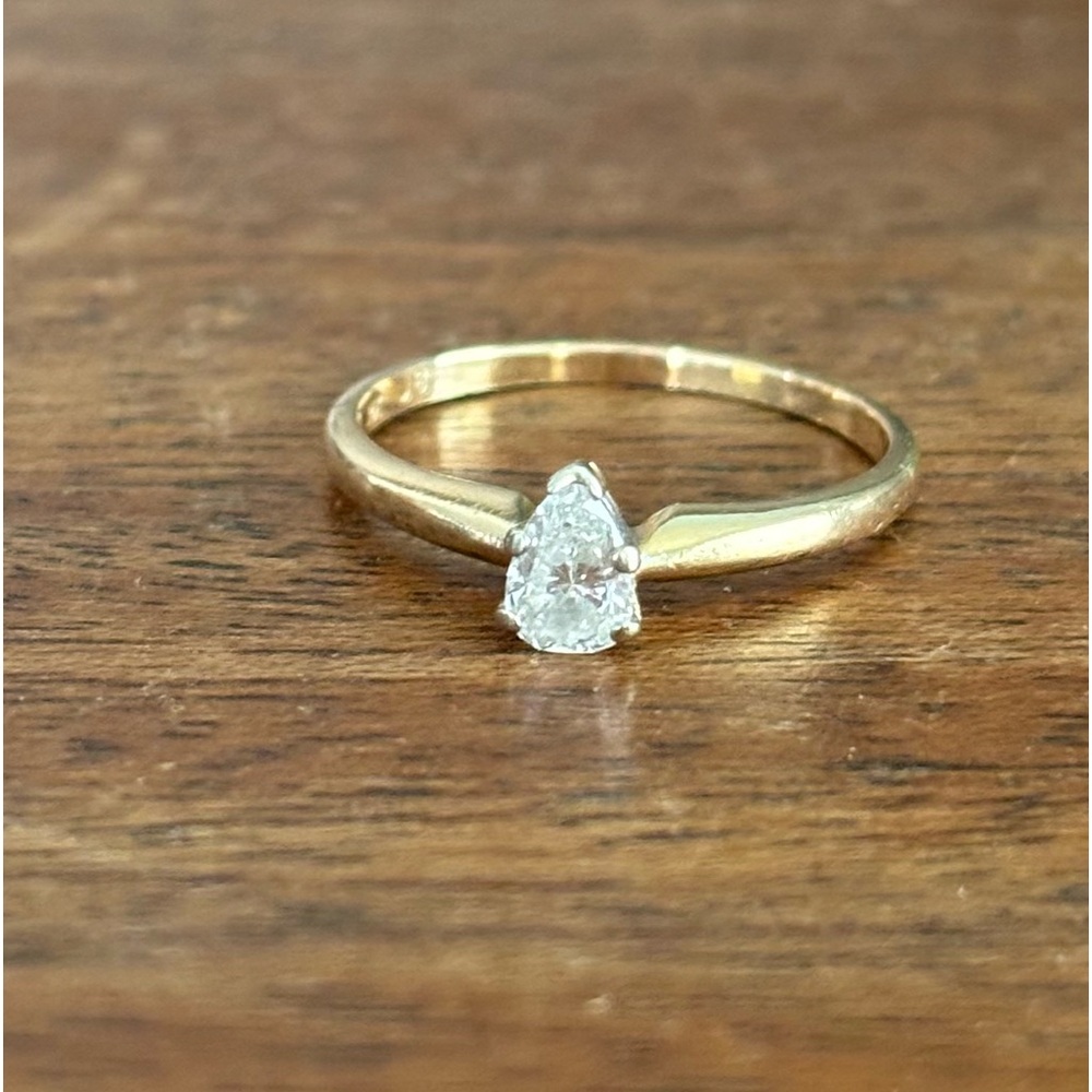 Pear shaped diamond solitaire ring set in 14k yellow gold